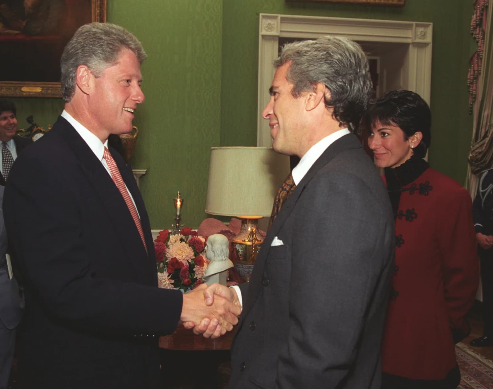 Bill Clinton shaking hands with Jeffrey Epstein at a White House donor event in 1993 while Ghislaine Maxwell stands nearby