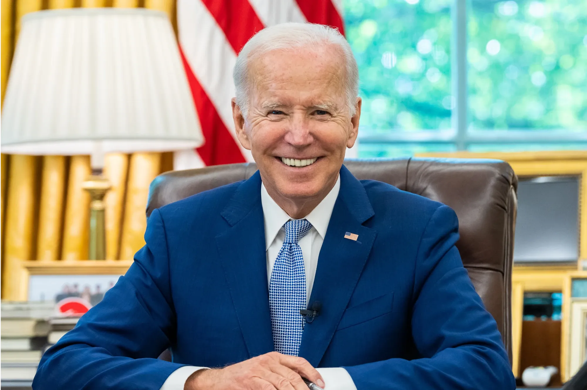 President Joe Biden seated in the Oval Office